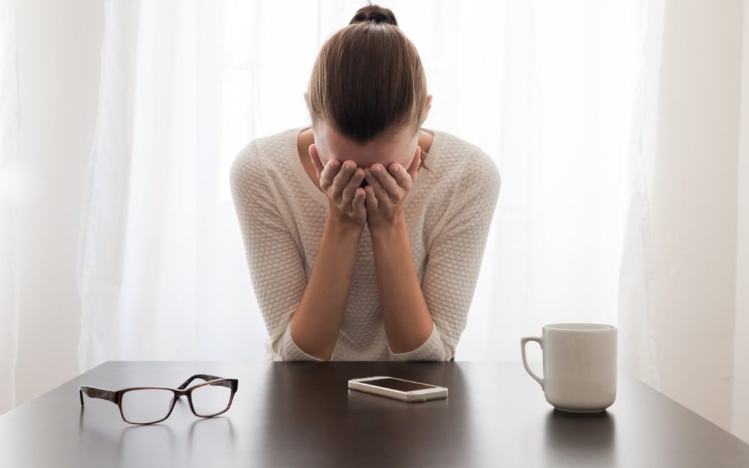 anxious woman with her face in her hands