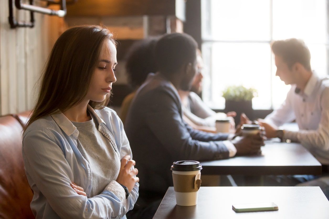 Woman with social anxiety in coffee shop