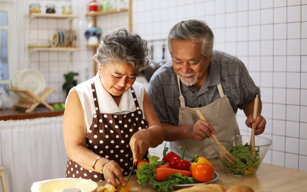 Happy Asian American Couple cooking together