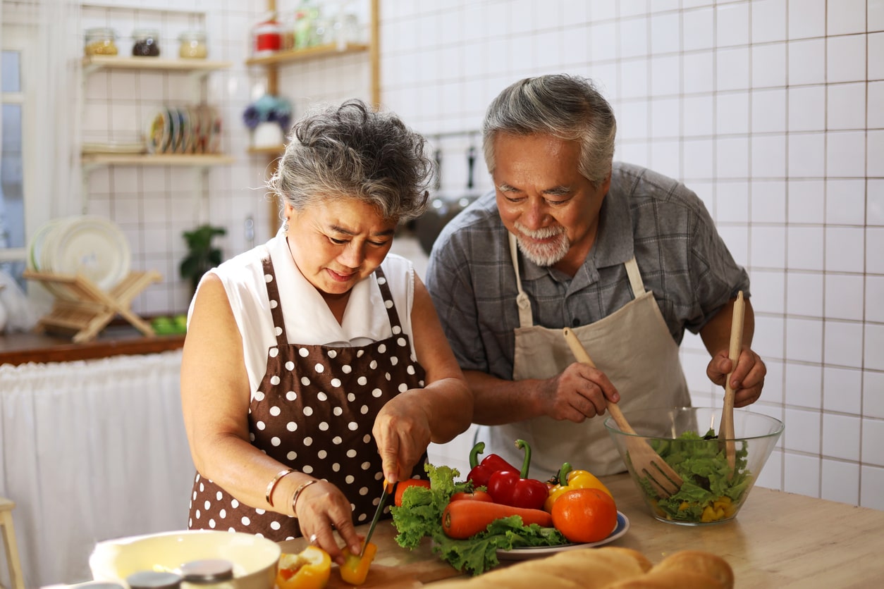 Happy Asian American Couple cooking together