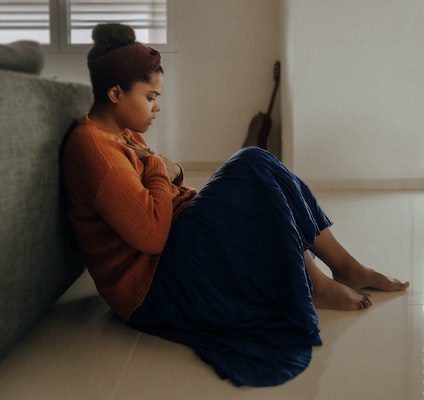 anxious woman sitting on the ground