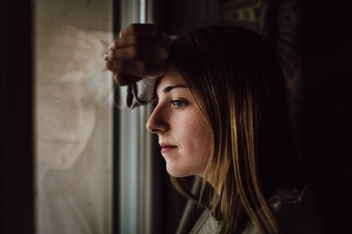 sad woman watching out the window