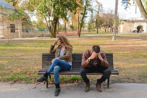 couple fighting on a park bench